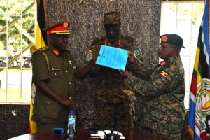 JS LEGAL SERVICES OUTGOING BRIG GEN PROFF GODARD BUSINGYE HANDS OVER OFFICE TO NEW JS BRIG GEN MOSES WANDERA AS PRESIDING OFFICER MAJ GEN BOB OGIK LOOKS ON 1